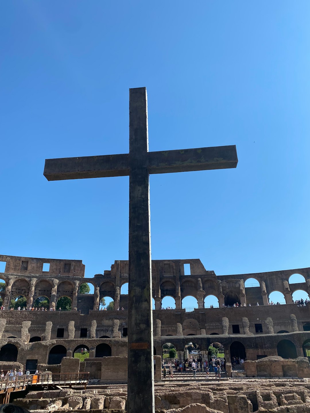 a cross in front of a building